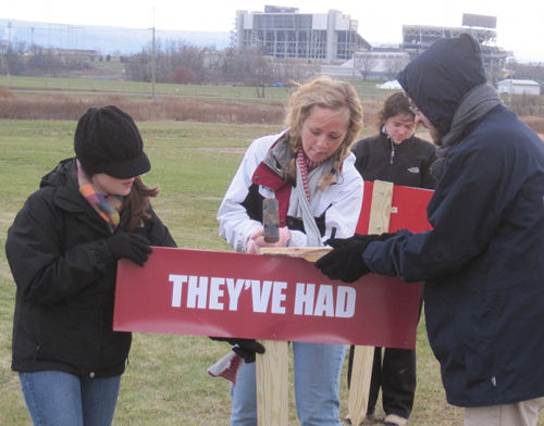 hammering in the signs in front of Beaver Stadium